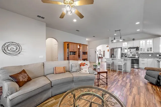 a view of a dining room with furniture a chandelier and wooden floor