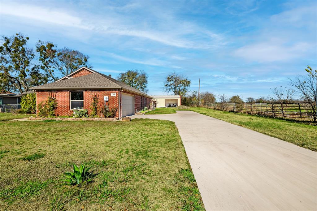 1209 Sherman Street Tioga, TX 76271 - Photo 3 of 40 a front view of a house with garden