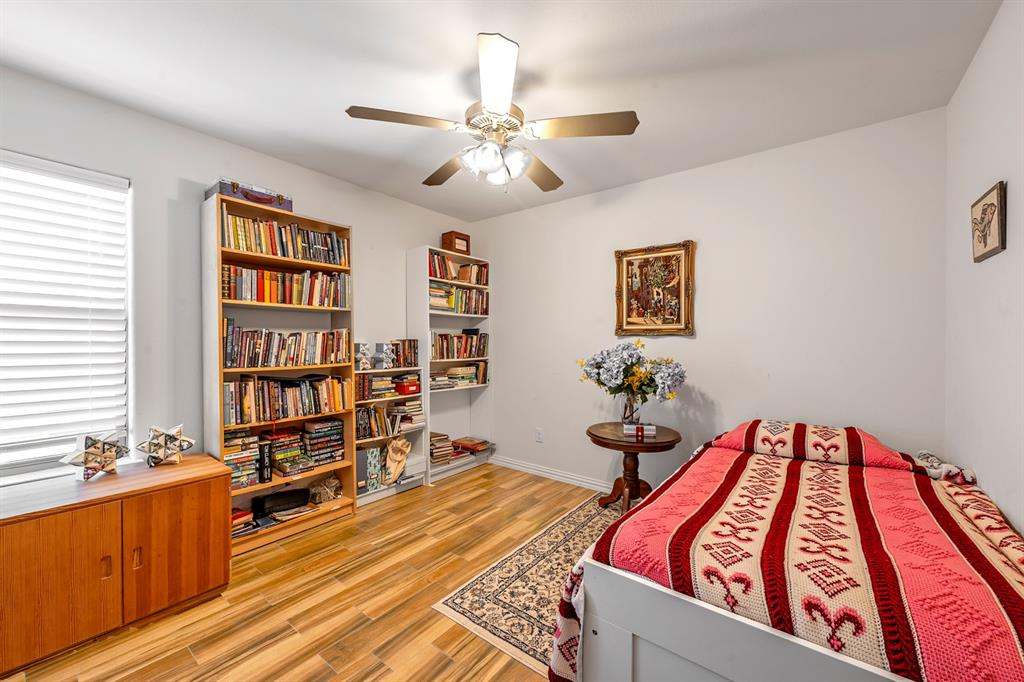 1209 Sherman Street Tioga, TX 76271 - Photo 32 of 40 a bedroom with furniture and a book shelf