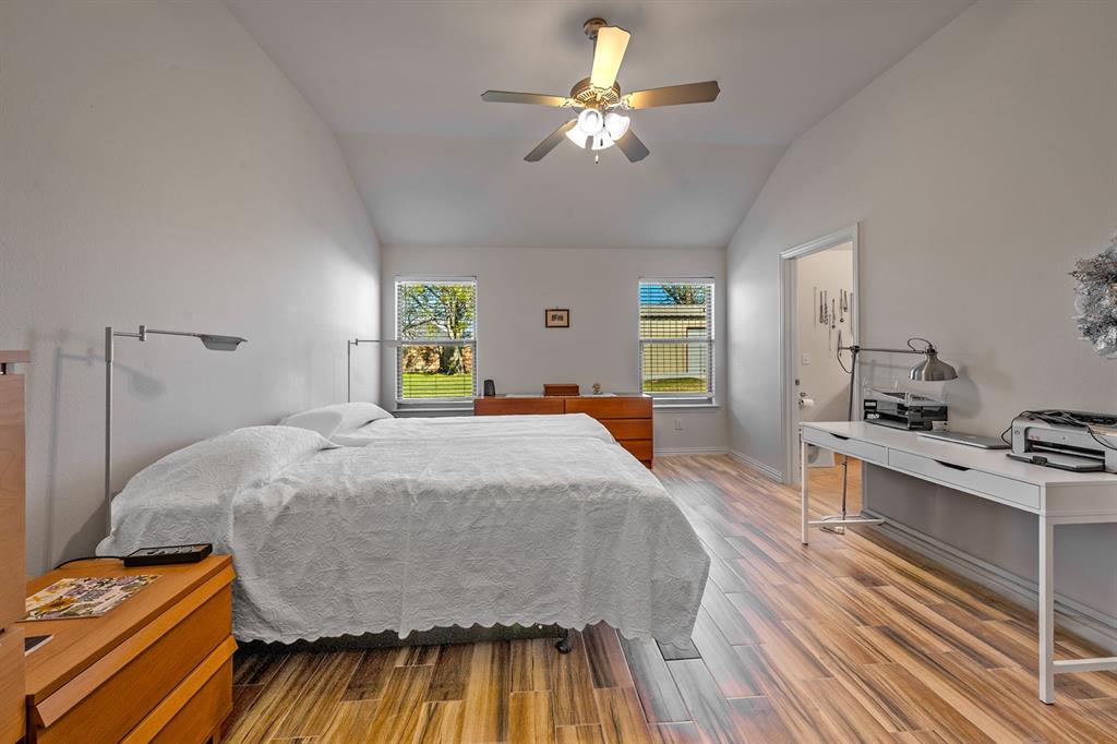 1209 Sherman Street Tioga, TX 76271 - Photo 34 of 40 a bedroom with a bed and a chandelier