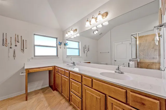 a bathroom with a double vanity sink and a mirror