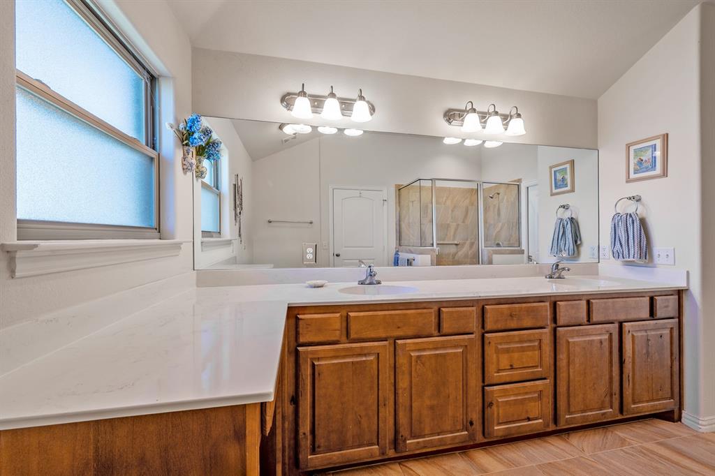 1209 Sherman Street Tioga, TX 76271 - Photo 38 of 40 a bathroom with a double vanity sink and a mirror