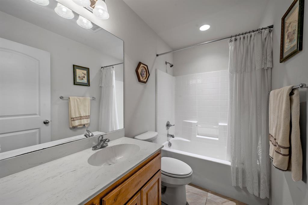 1209 Sherman Street Tioga, TX 76271 - Photo 39 of 40 a bathroom with a granite countertop sink toilet and shower