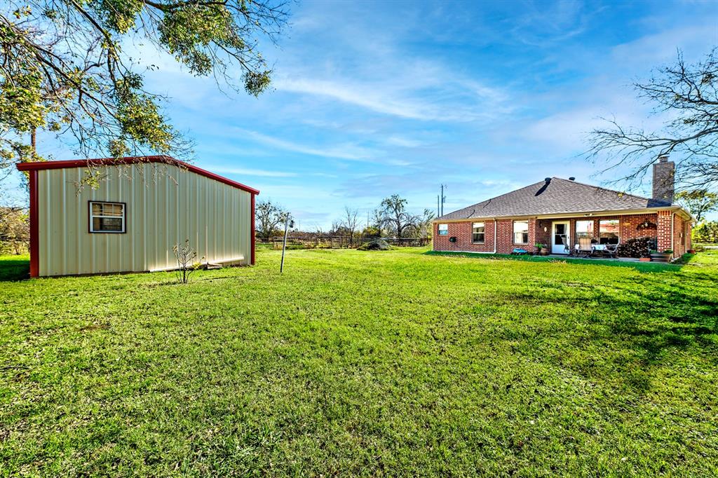 1209 Sherman Street Tioga, TX 76271 - Photo 8 of 40 a backyard of a house with lots of green space