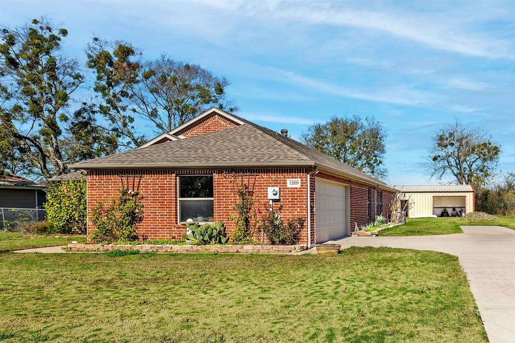 1209 Sherman Street Tioga, TX 76271 - Photo 10 of 40 a front view of a house with garden