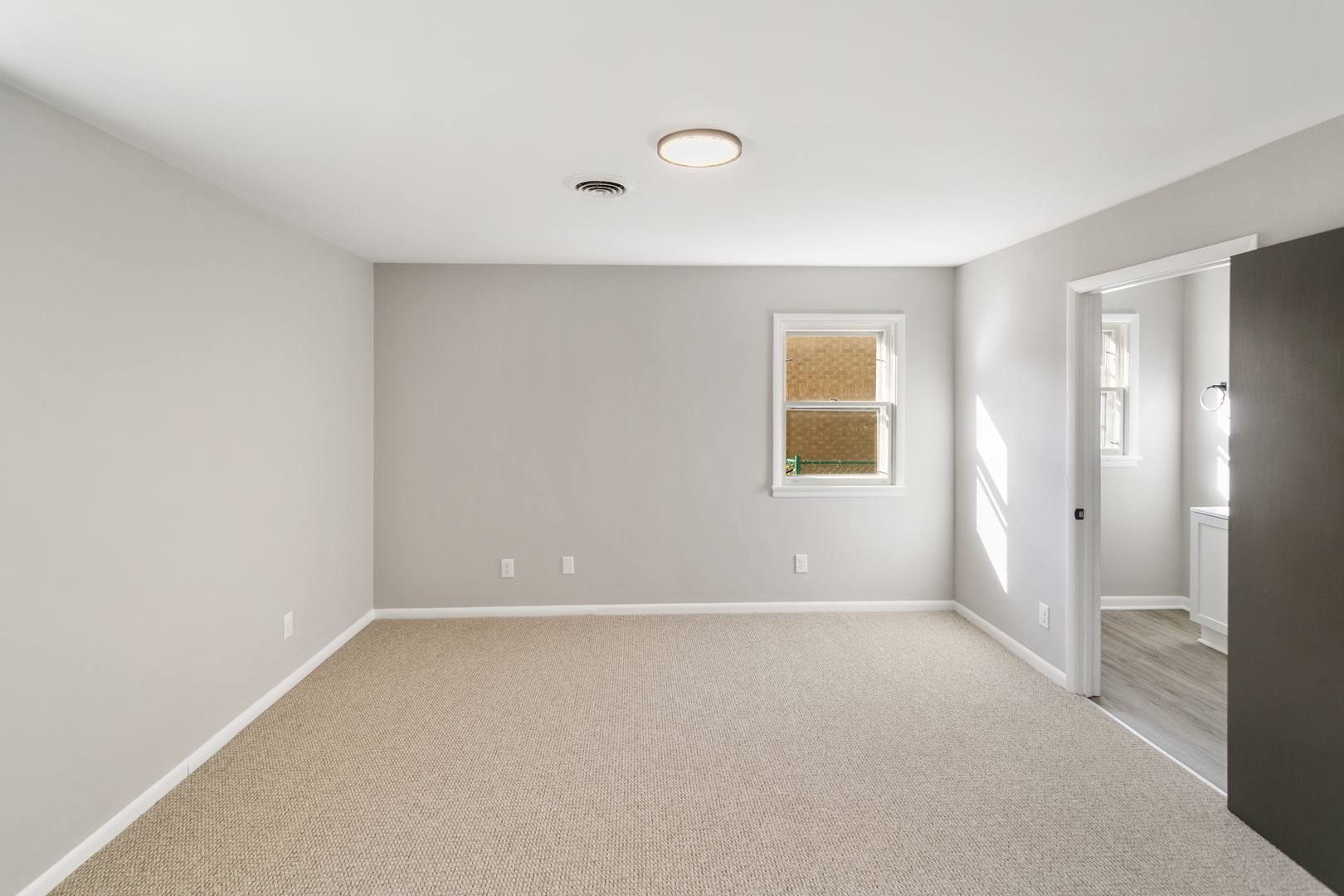 1431 West Vanmeter Street Kankakee, IL 60901 - Photo 11 of 19 a view of an empty room with a window