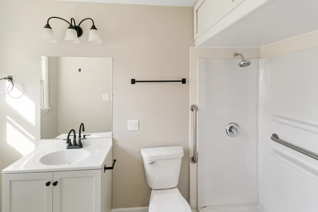 a bathroom with a sink toilet and shower