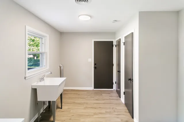 a view of a room with wooden floor and furniture