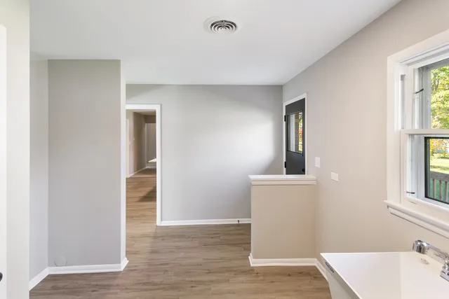 wooden floor in an empty room with a window