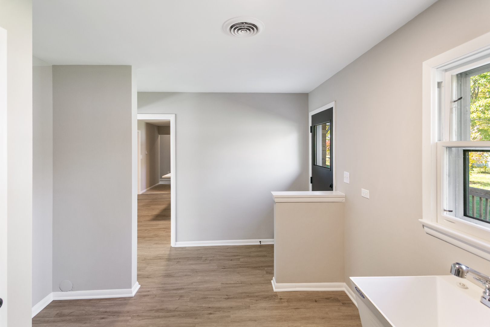 1431 West Vanmeter Street Kankakee, IL 60901 - Photo 8 of 19 wooden floor in an empty room with a window