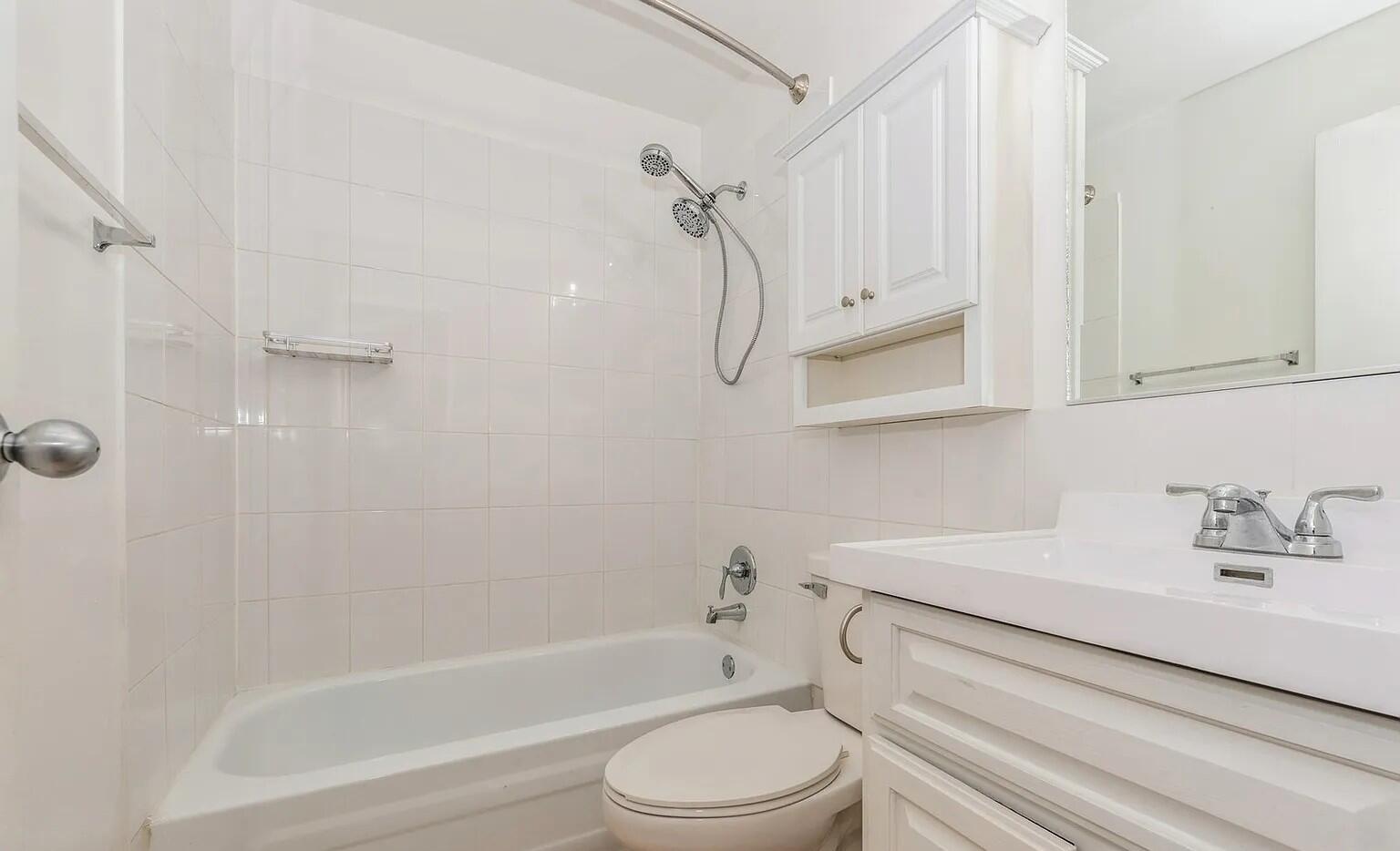 3900 North Pine Grove Avenue, Unit 405 Chicago, IL 60613 - Photo 13 of 15 a bathroom with a sink a toilet and a bathtub