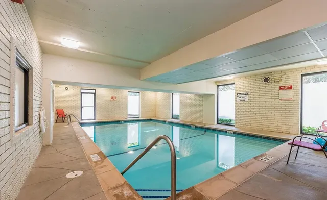 a hallway with a large window and potted plants