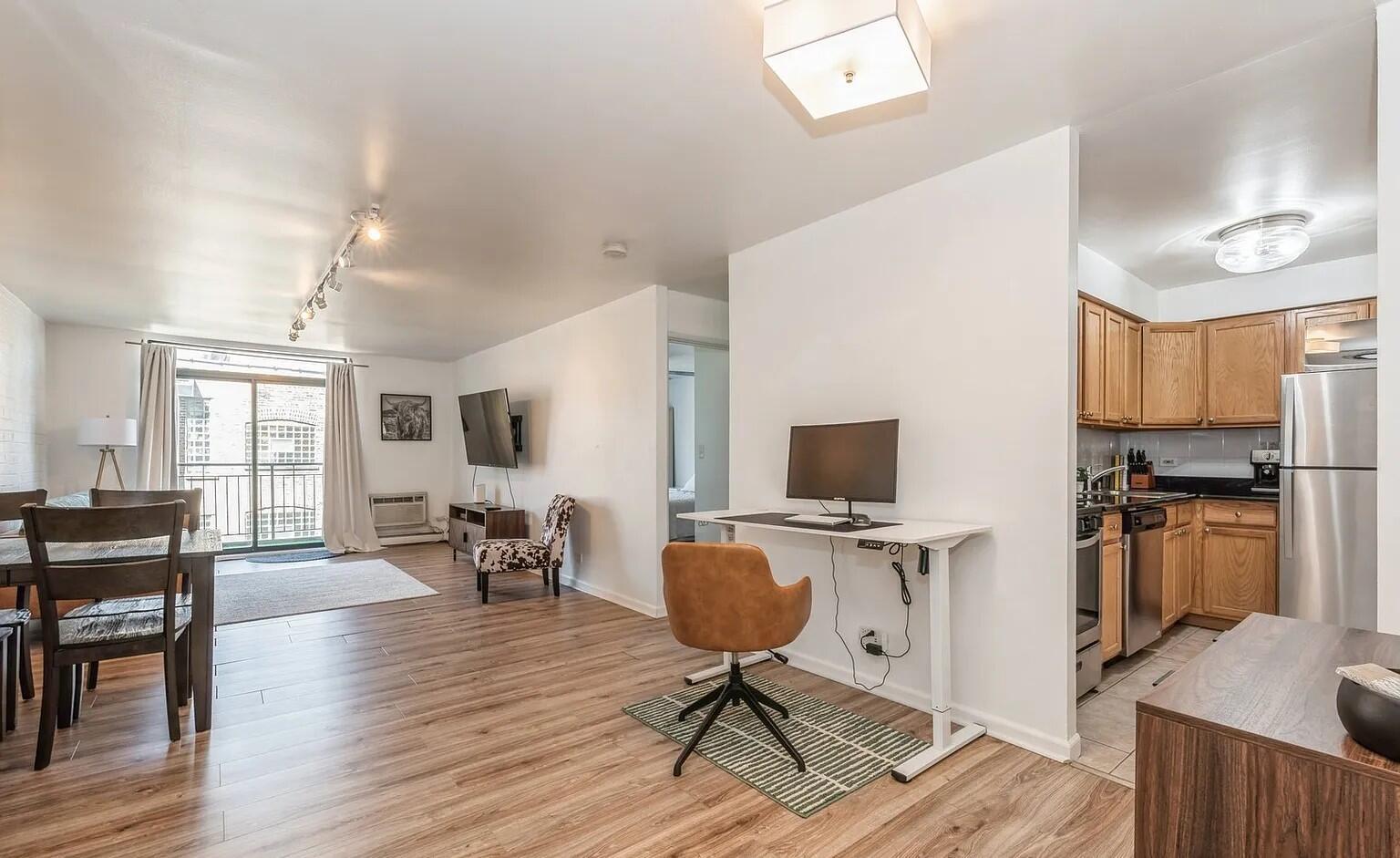 3900 North Pine Grove Avenue, Unit 405 Chicago, IL 60613 - Photo 8 of 15 a view of a workspace with furniture and a flat screen tv