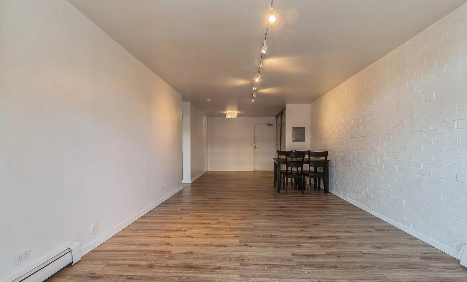 3900 North Pine Grove Avenue, Unit 405 Chicago, IL 60613 - Photo 9 of 15 a view of kitchen and dining room with wooden floor