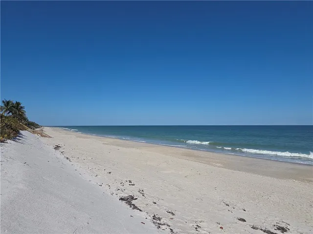 a view of a swimming pool with outdoor seating