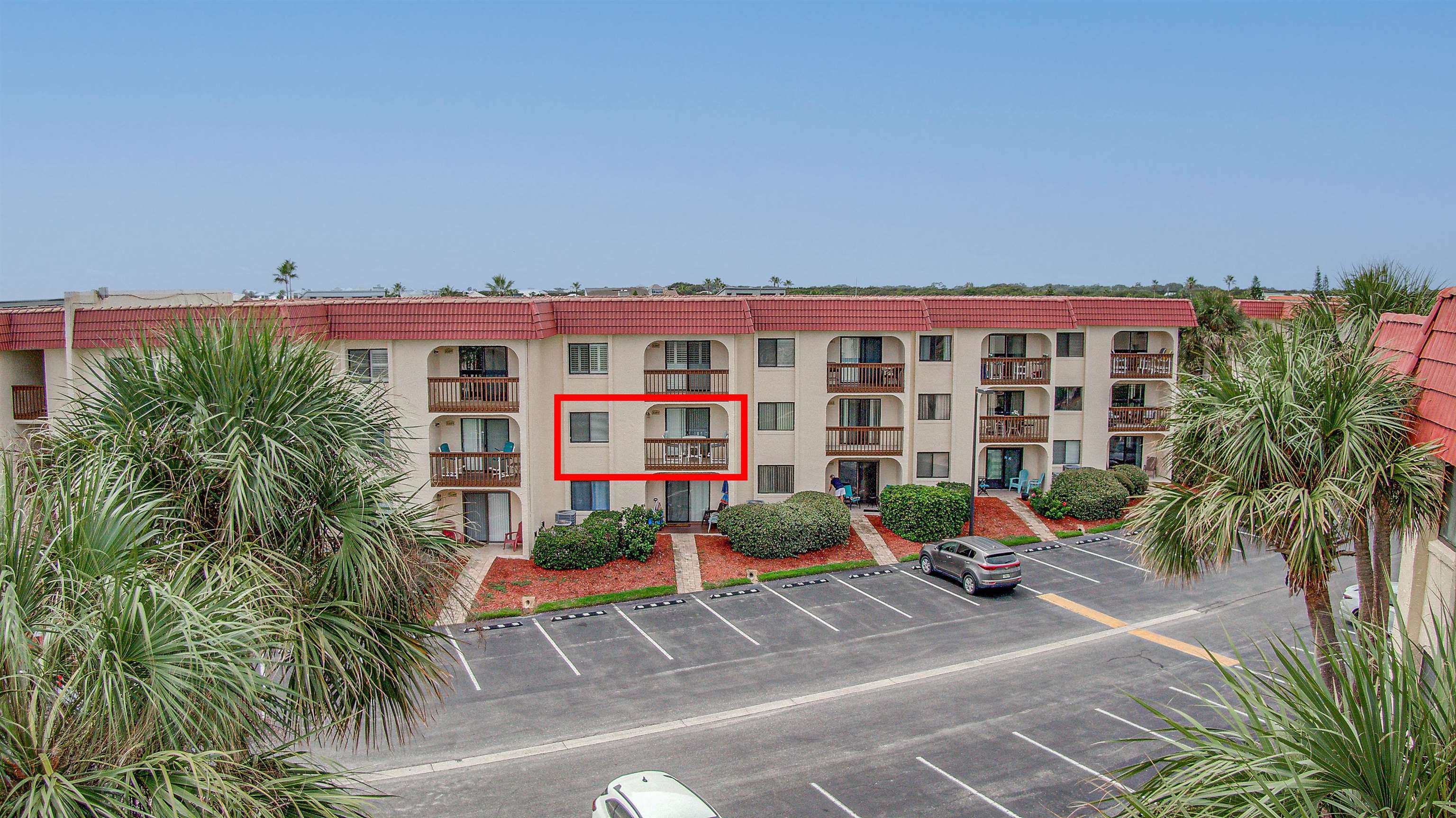 880 A1A Beach Boulevard, Unit 3207 St. Augustine, FL 32080 - Photo 22 of 33 a view of a tall building with a yard and plants