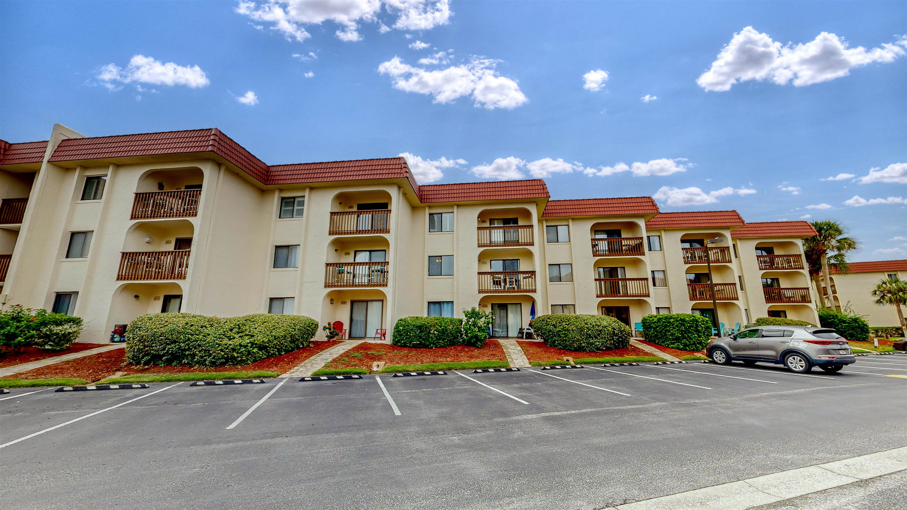 880 A1A Beach Boulevard, Unit 3207 St. Augustine, FL 32080 - Photo 23 of 33 a cars parked in front of a building