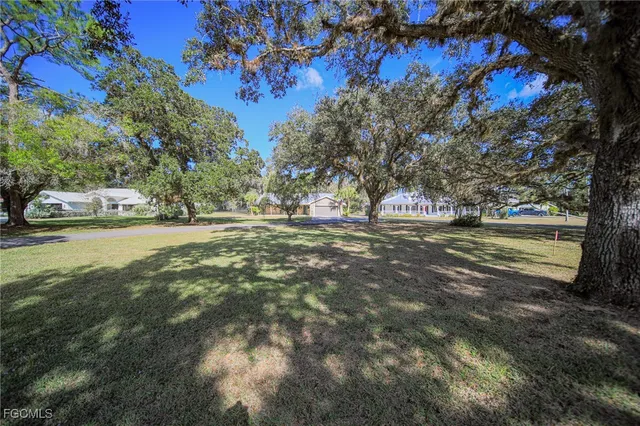 a view of a street with a building and trees in the background