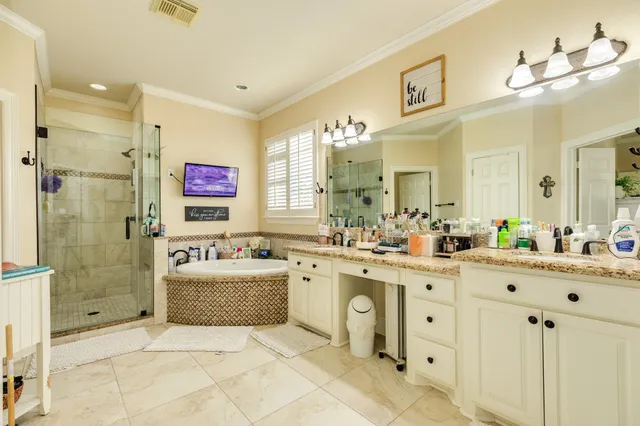 a bathroom with a tub sink and mirror