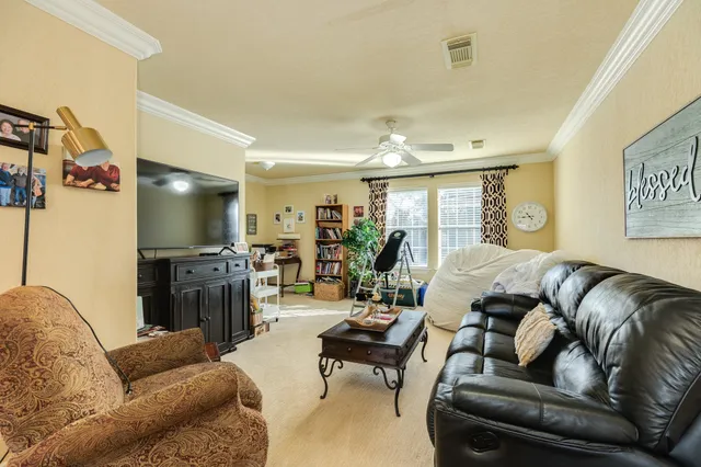 a living room with furniture and a book shelf
