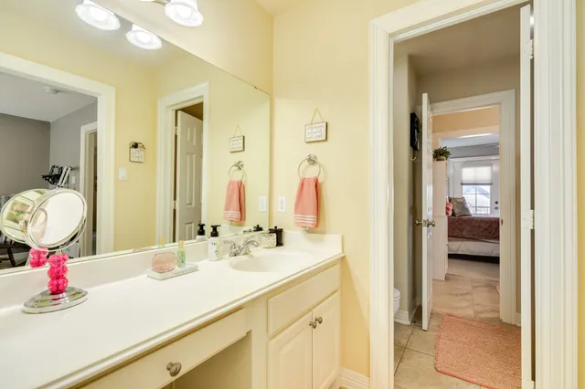 a bathroom with a granite countertop toilet sink and mirror