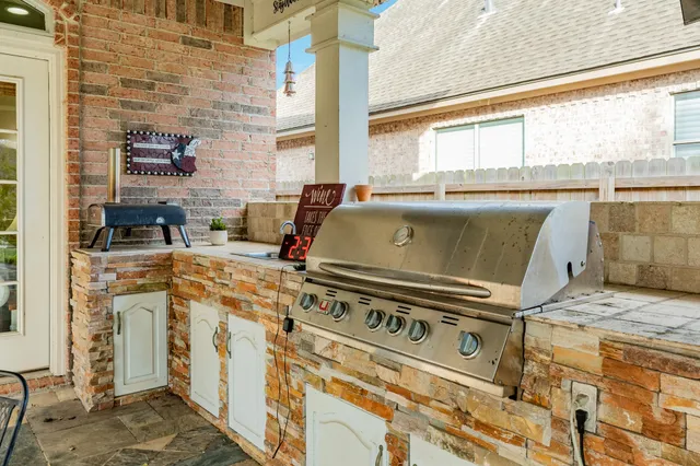 a stove top oven sitting next to a window