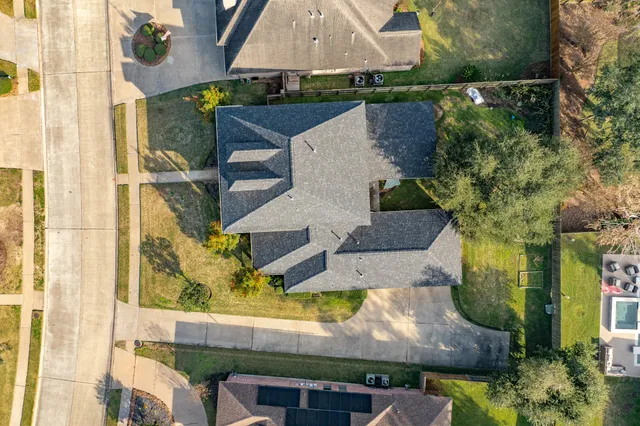 an aerial view of residential houses with outdoor space