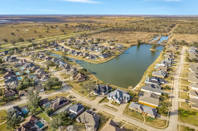 an aerial view of residential building and ocean