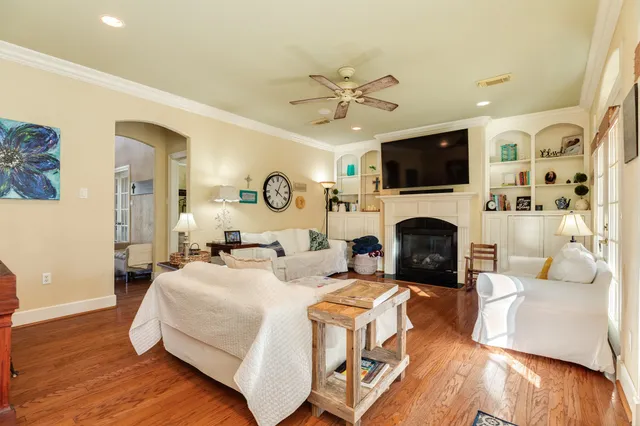 a living room with furniture a fireplace and a flat screen tv