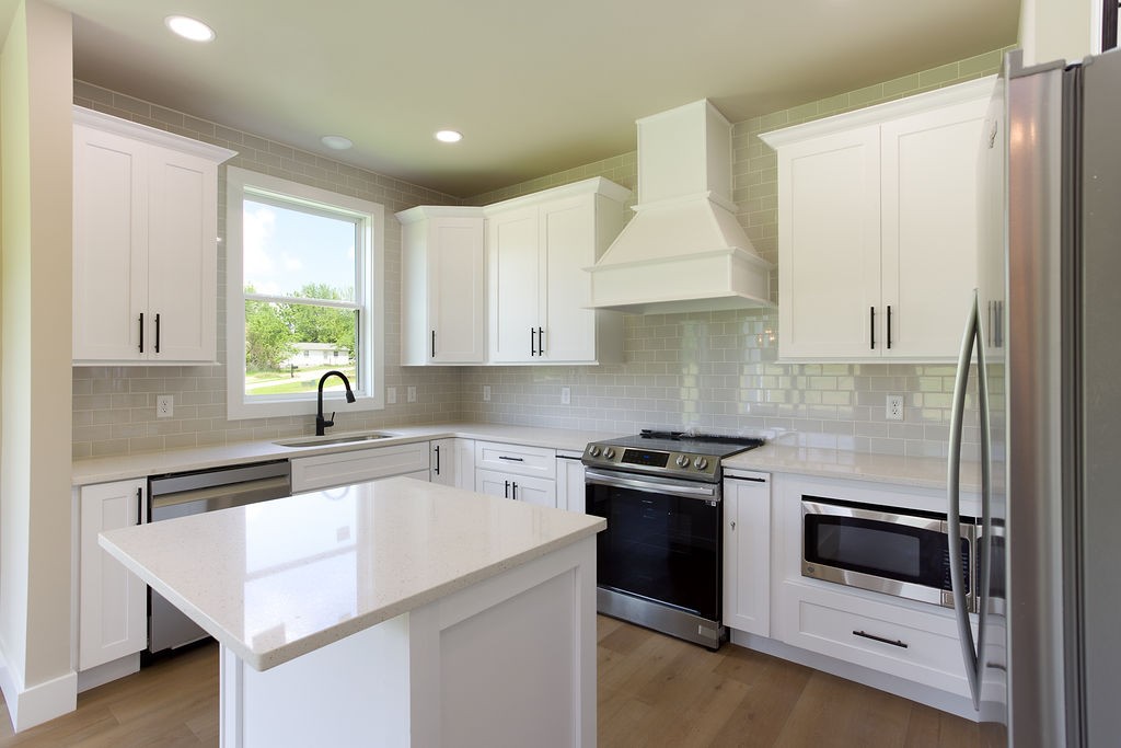 803 Oconner Smithville, TN 37166 - Photo 5 of 26 a kitchen with a stove a sink and a refrigerator