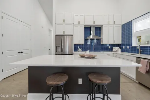 a kitchen with a sink a stove and cabinets