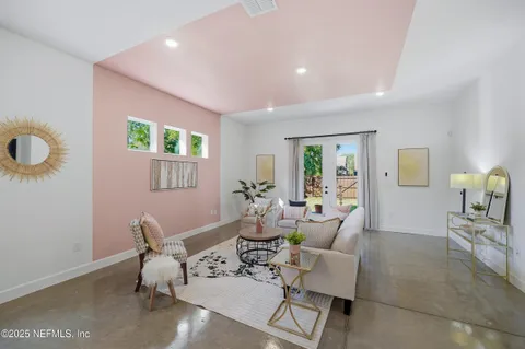 a living room with furniture and a potted plant