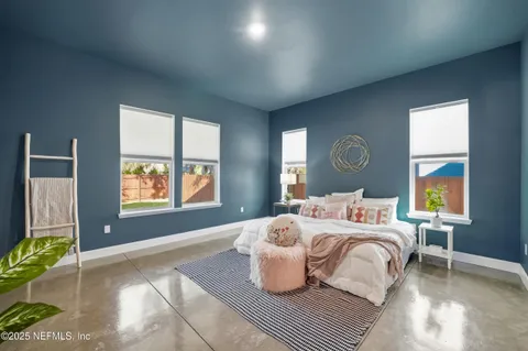 a spacious bedroom with a bed and a cabinets