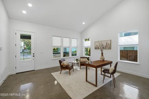 a living room with furniture a rug and a window