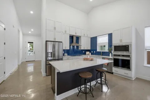 a kitchen with stainless steel appliances a sink and cabinets