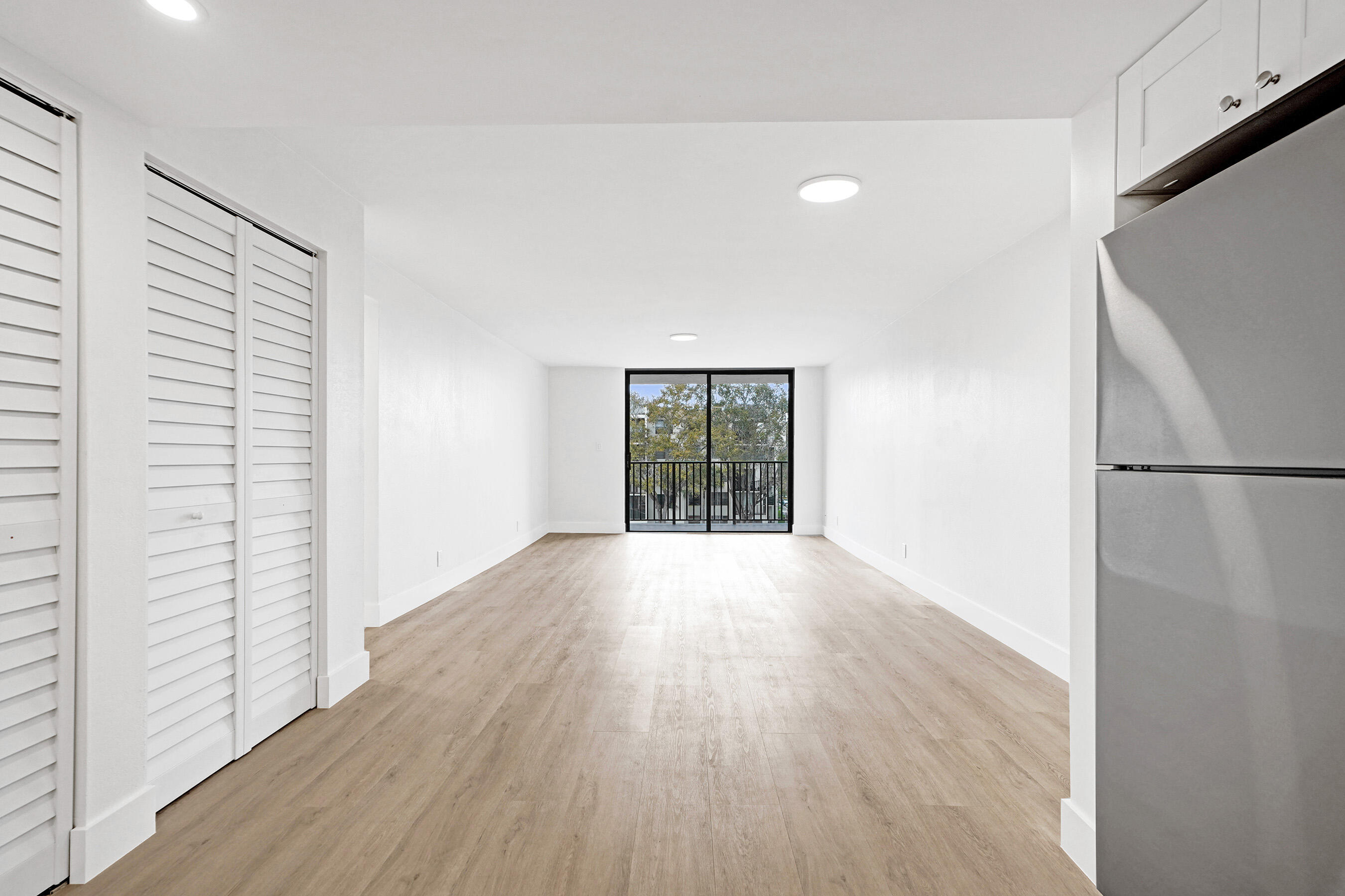 6195 Rock Island Road, Unit 413 Tamarac, FL 33319 - Photo 11 of 37 a view of an empty room with wooden floor and a window