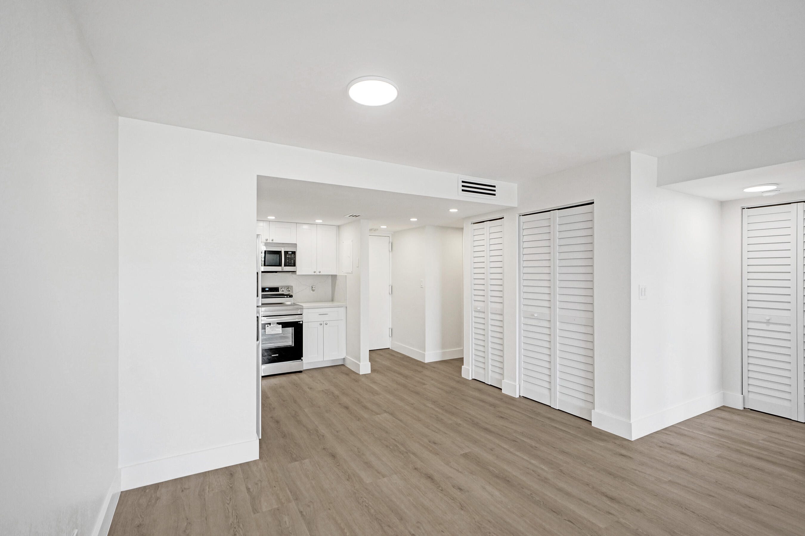 6195 Rock Island Road, Unit 413 Tamarac, FL 33319 - Photo 16 of 37 a view of empty room with wooden floor