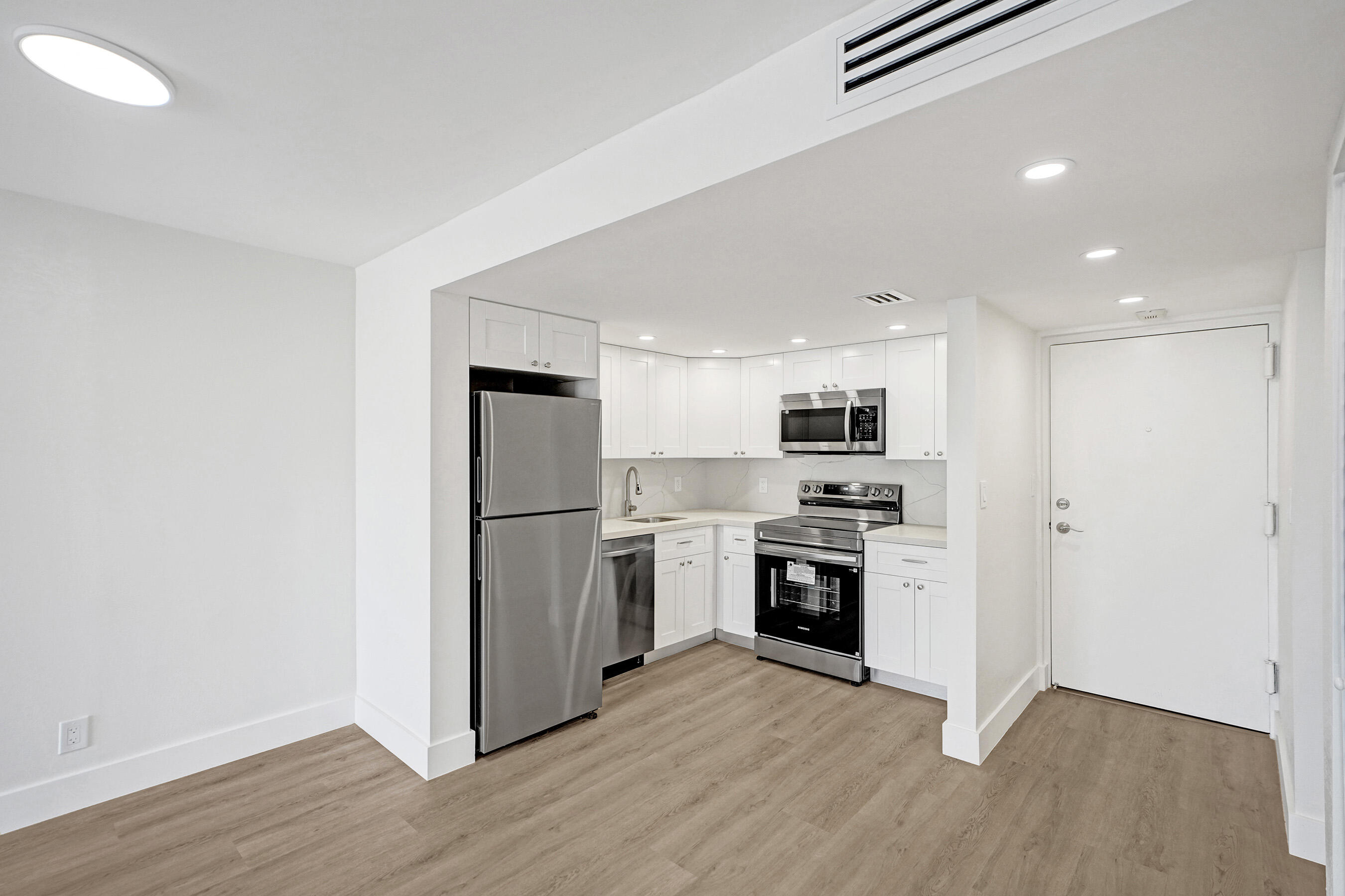 6195 Rock Island Road, Unit 413 Tamarac, FL 33319 - Photo 18 of 37 a kitchen with a refrigerator a stove top oven and kitchen island
