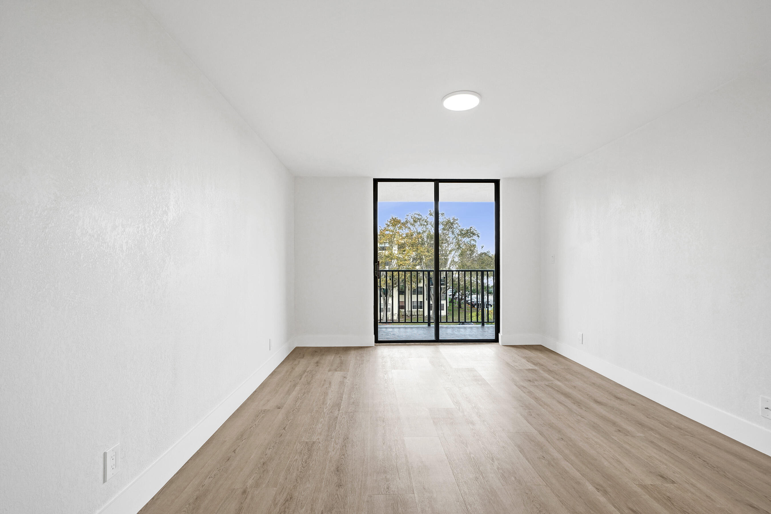 6195 Rock Island Road, Unit 413 Tamarac, FL 33319 - Photo 22 of 37 wooden floor in an empty room with a window