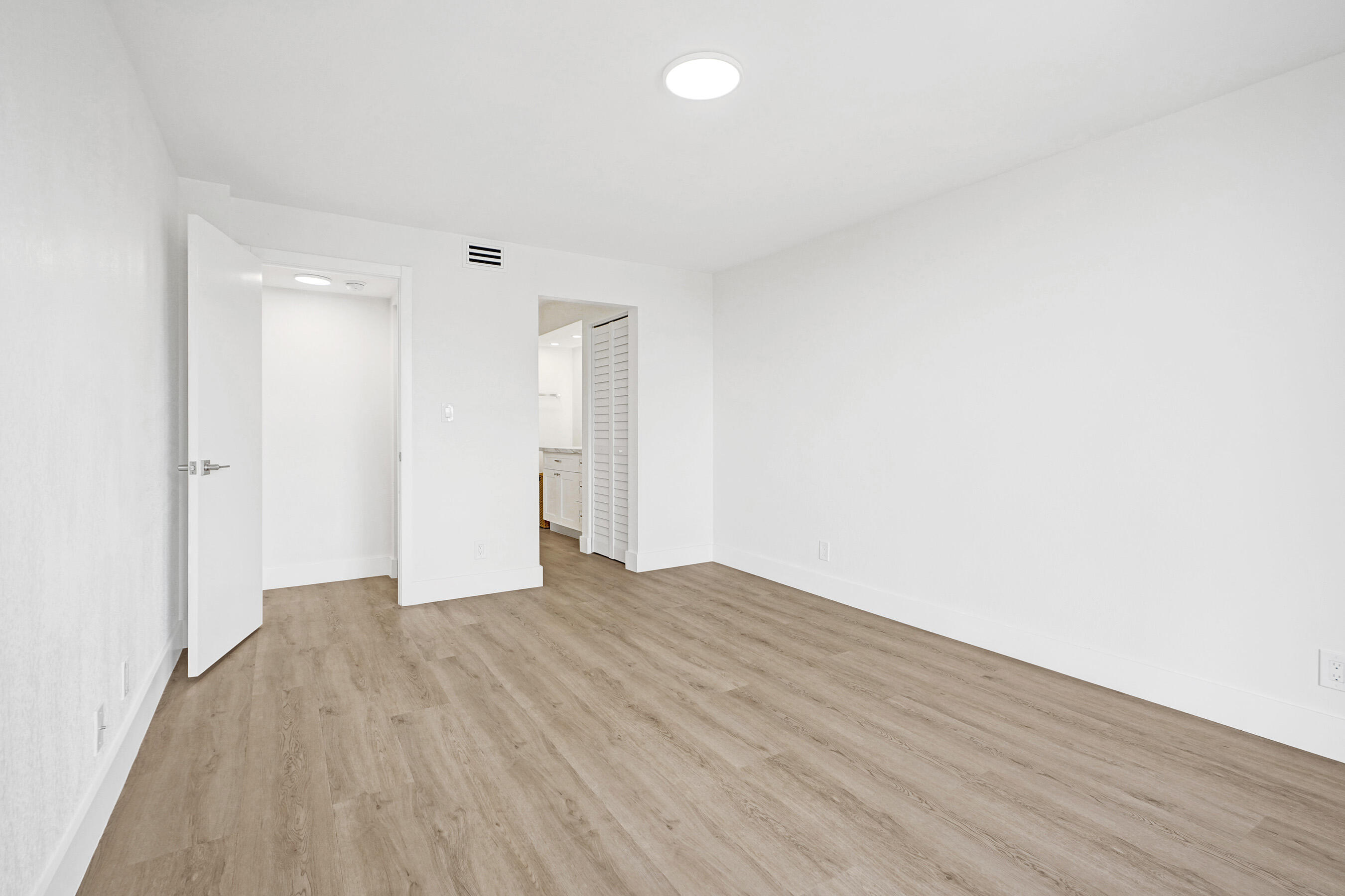 6195 Rock Island Road, Unit 413 Tamarac, FL 33319 - Photo 24 of 37 a view of an empty room with wooden floor