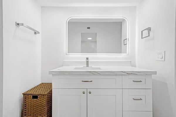 a bathroom with a sink and a mirror