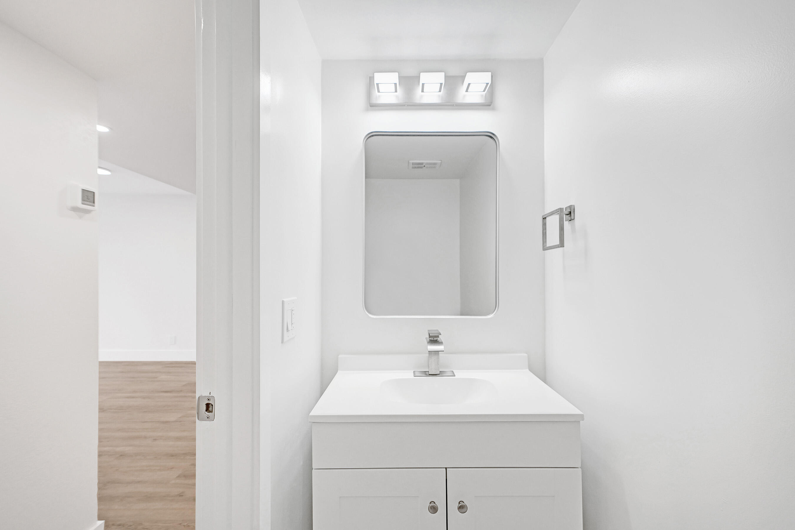 6195 Rock Island Road, Unit 413 Tamarac, FL 33319 - Photo 7 of 37 a bathroom with a sink and a mirror