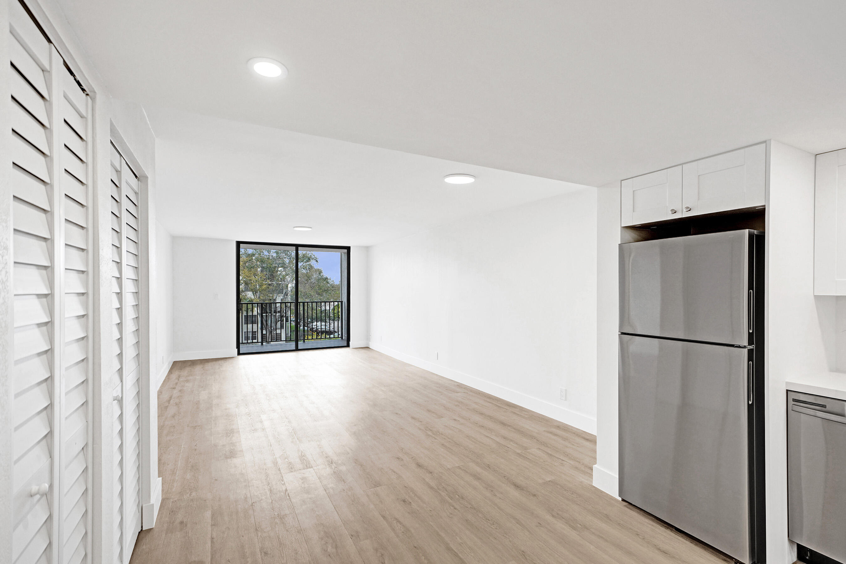6195 Rock Island Road, Unit 413 Tamarac, FL 33319 - Photo 8 of 37 a view of an empty room with wooden floor and a window