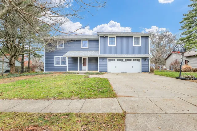 a front view of a building with a garden