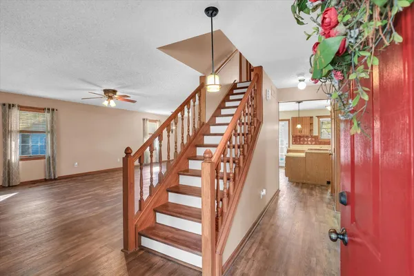 a bathroom with a granite countertop sink a toilet and shower