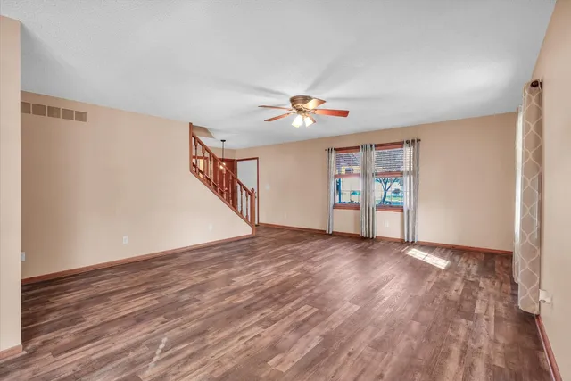 an empty room with windows and closet
