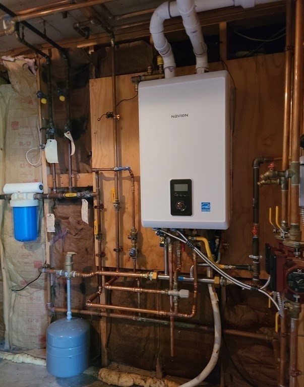 80 West Main Street Ware, MA 01082 - Photo 19 of 27 a room with water heater and wooden cabinets