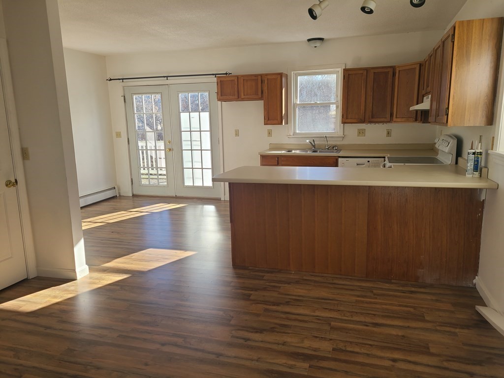 80 West Main Street Ware, MA 01082 - Photo 4 of 27 a view of kitchen with wooden floor and electronic appliances