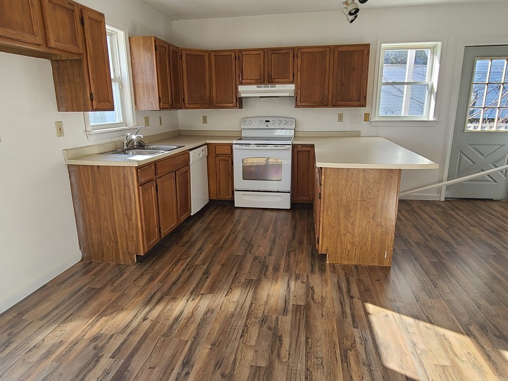 80 West Main Street Ware, MA 01082 - Photo 5 of 27 a kitchen with wooden floors and wooden cabinets
