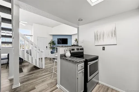 a kitchen with cabinets and wooden floor